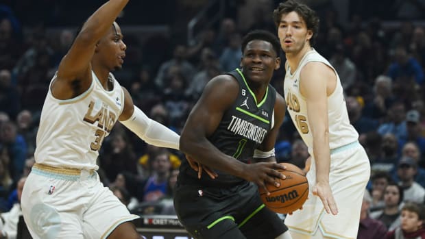 Nov 13, 2022; Cleveland, Ohio, USA; Minnesota Timberwolves guard Anthony Edwards (1) drives to the basket against Cleveland Cavaliers forward Isaac Okoro (35) and forward Cedi Osman (16) during the first half at Rocket Mortgage FieldHouse.